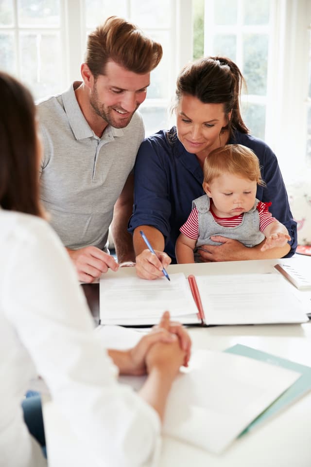 Family signing insurance documents